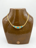 Collier à maillons dorés et pierres turquoises